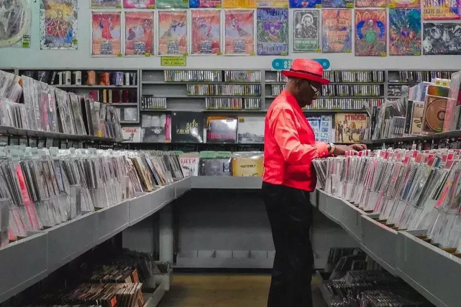 A man in a red jacket shops for records at Amoeba Records in San Francisco.